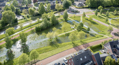 luchtfoto van veel groen langs straten en bij huizen