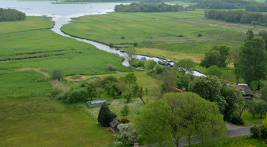 Luchtfoto landschap met sloot ertussen en huisjes