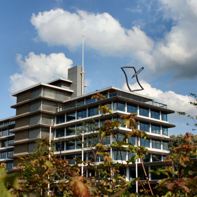 Foto van het provinciehuis tussen de bomen door